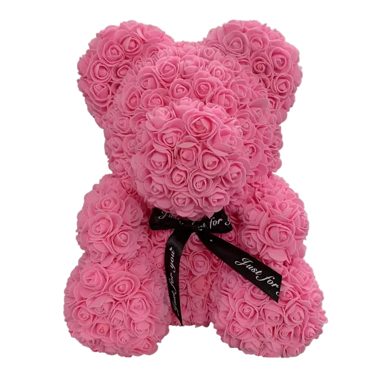 Pink teddy bear made of roses with a black ribbon on a white background