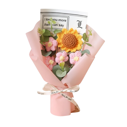 MieleGifts handcrafted crochet flower bouquet featuring a yellow sunflower, pink daisies, and eucalyptus in pink wrap.