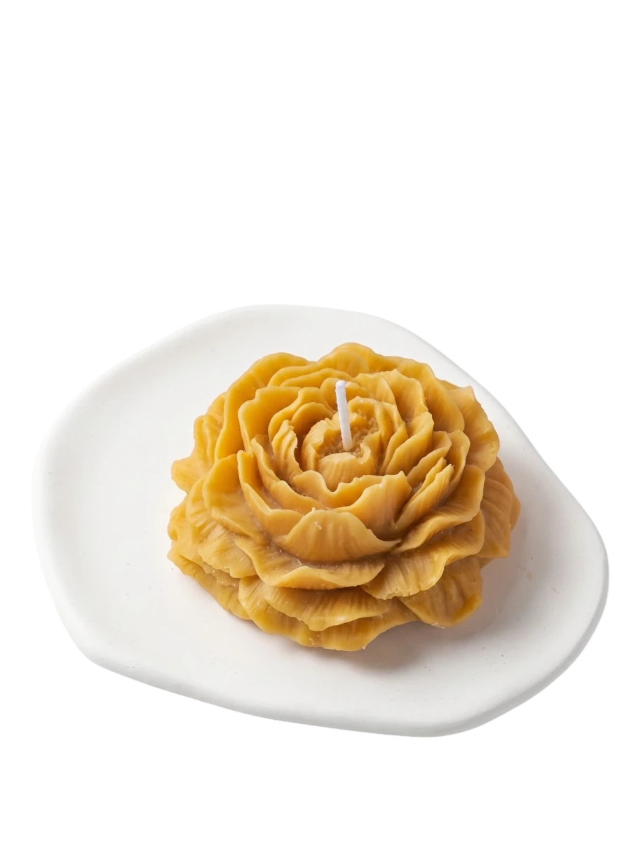 MieleGifts golden yellow peony shaped soy wax candle on a white ceramic tray