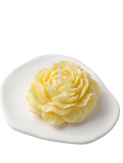 MieleGifts yellow peony flower shaped soy wax candle on a white ceramic tray